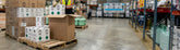 Warehouse interior with stacked boxes and pallets