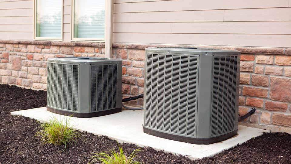 Multiple AC units beside a home.